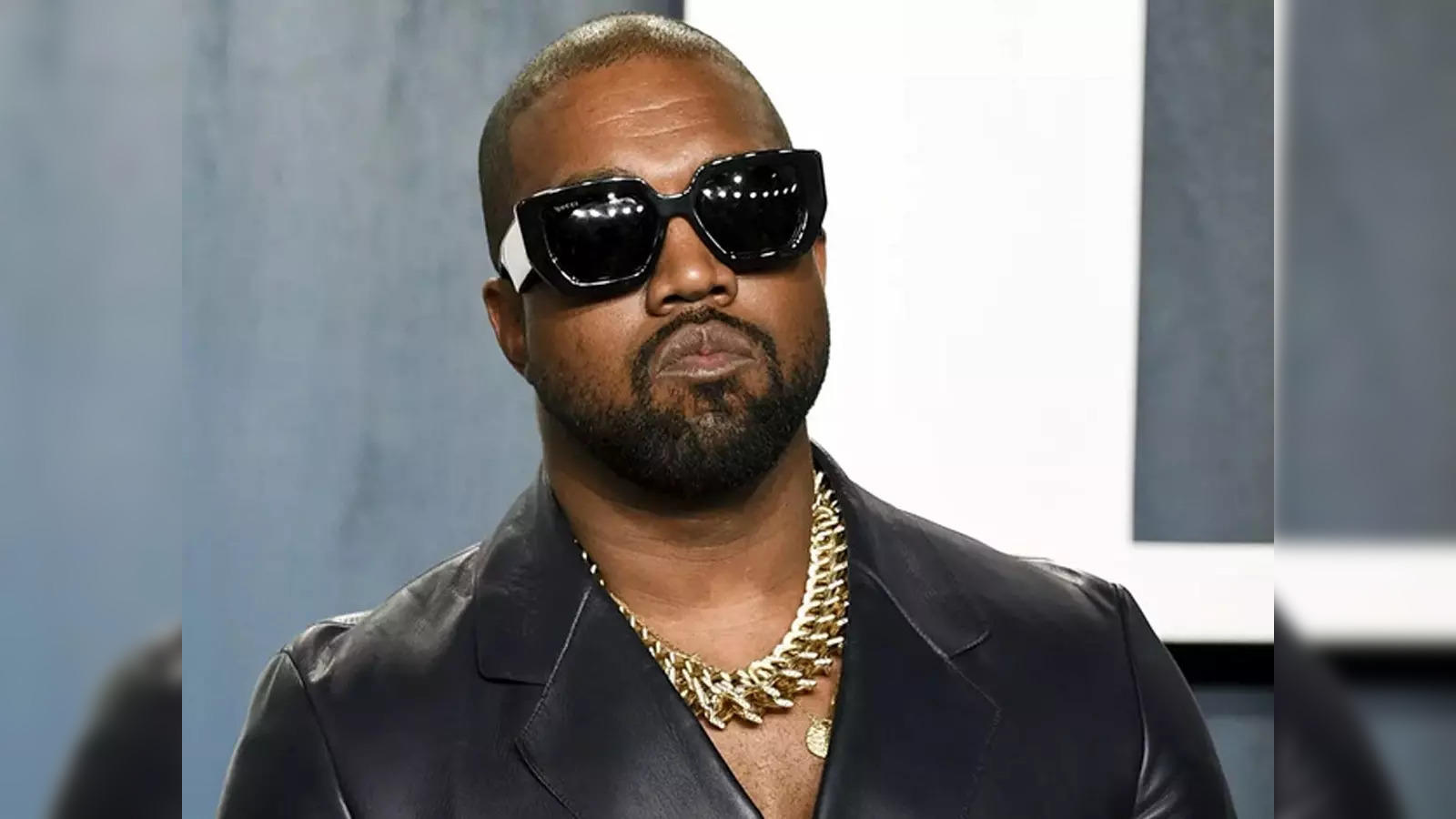 Kanye West sports a hockey jersey and gold chains as he leaves his