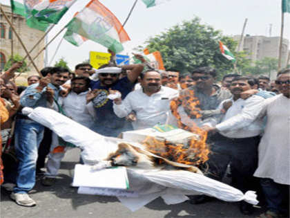 Protesters block railway tracks, burn Narendra Modi's effigy to protest rail fare hike