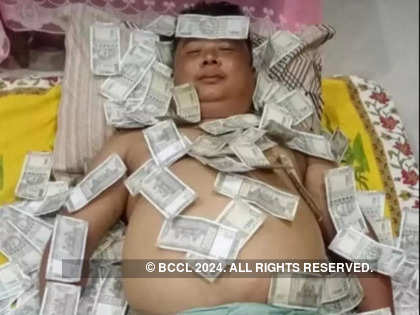 Photo of Assam politician sleeping on a pile of notes goes viral