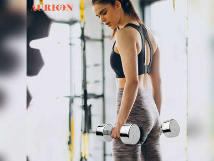 Download Determined Fitness Enthusiast Lifting Weights In A  State-of-the-art Gym.