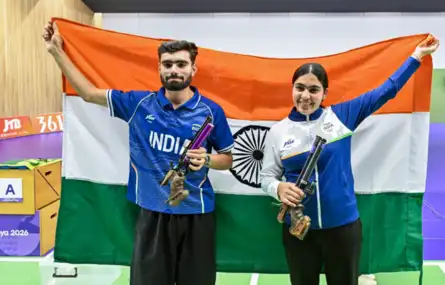 Asian Games 2026 Day 6 Live: India's Kamaljeet Singh and Suruchi Singh celebrate with the national flag after winning gold in the 10m Air Pistol Mixed Team final