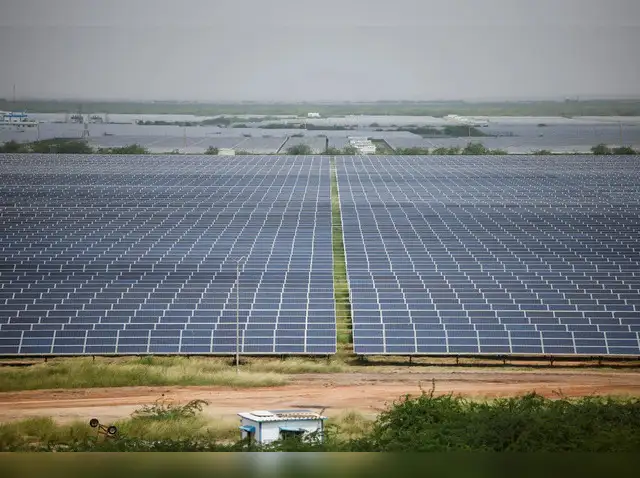 https://img.etimg.com/thumb/width-640%2Cheight-480%2Cimgsize-327208%2Cresizemode-75%2Cmsid-116494822/industry/renewables/parliament-panel-suggests-strict-timelines-for-solar-park-developments/a-general-view-of-solar-panels-at-gujarat-solar-park-also-called-charanka-solar-park-at-patan-district-in-gujarat.jpg