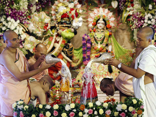 Saints of Hare Krishna Temple pour Milk over the idol of Lord Krishna on the occasion of the festival of Janmashtami.
